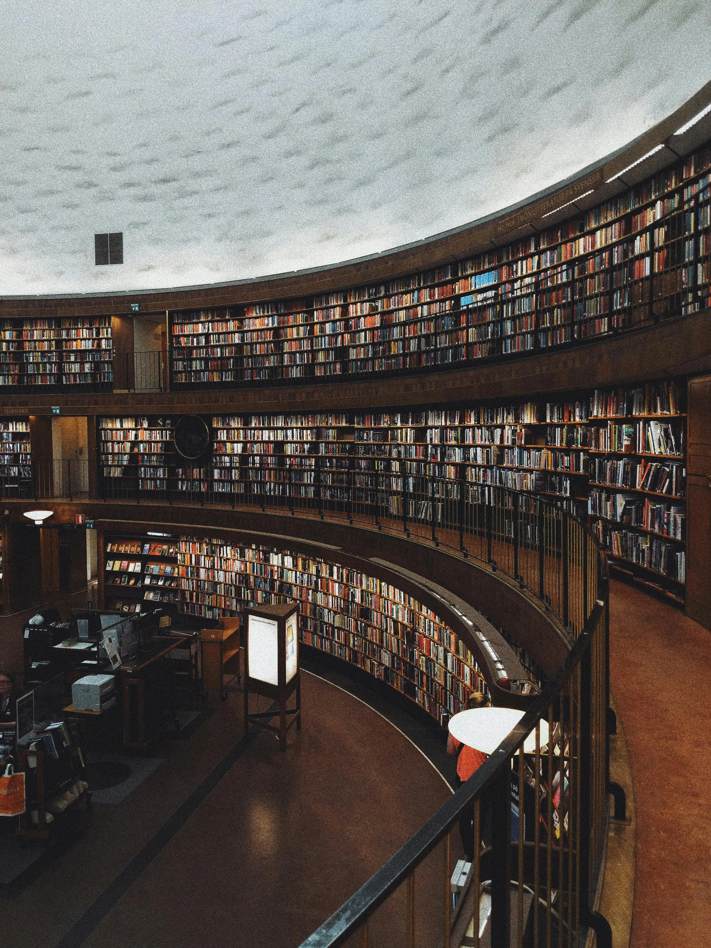 Scene of a library with shelves full of books.